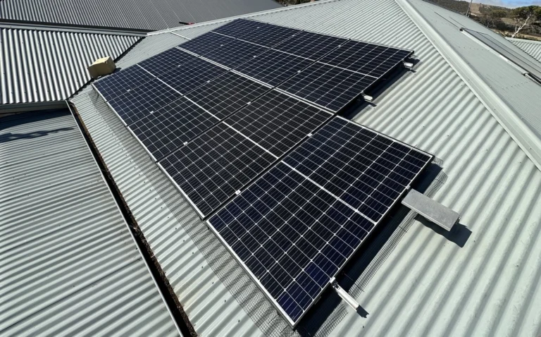 Bird proofing mesh fitted around the edge of a rooftop solar array on a Colorbond roof by NG Elec