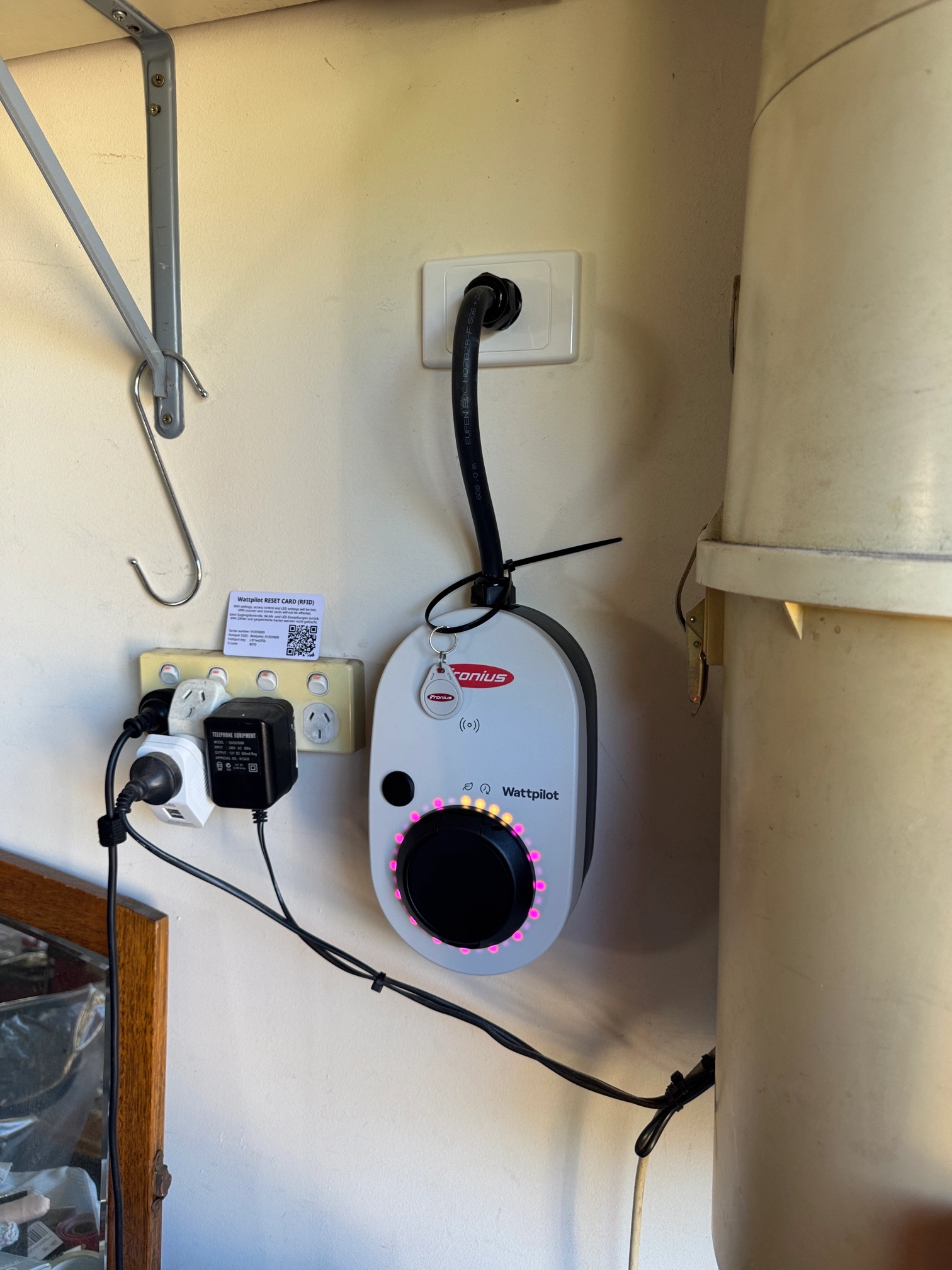Wall-mounted EV charger installed by NG Elec shown in portrait orientation